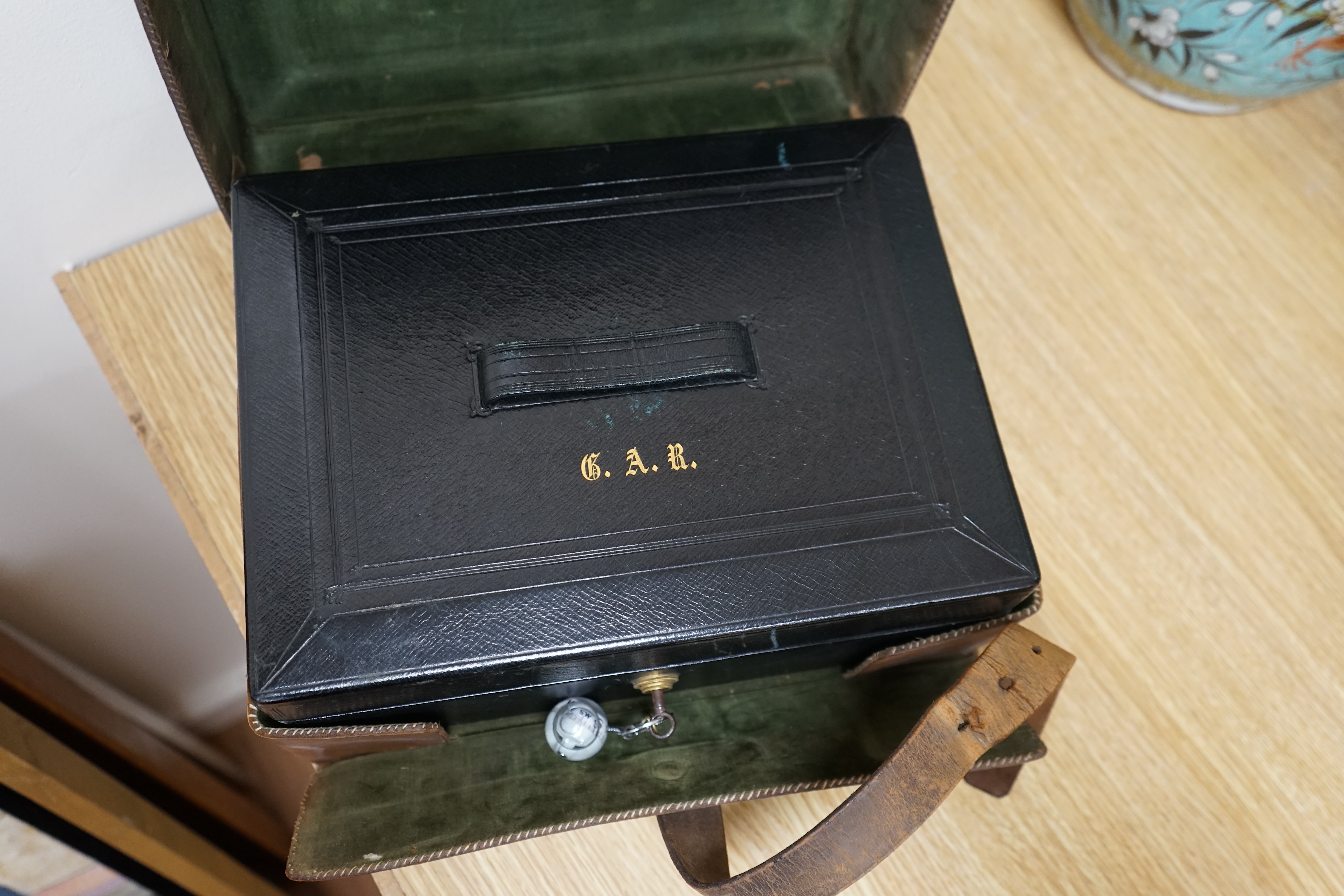 Wells & Lambert, London, a travelling writing box and outer leather case, with Bramah lock and keys, with monograms and inscriptions of Rev. George A. Robins, the box incorporating a silver lidded inkwell, 33cm wide. Con